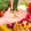 Hand,Is,Holding,Food,Supplement,Tabletts,Over,A,Wooden,Table